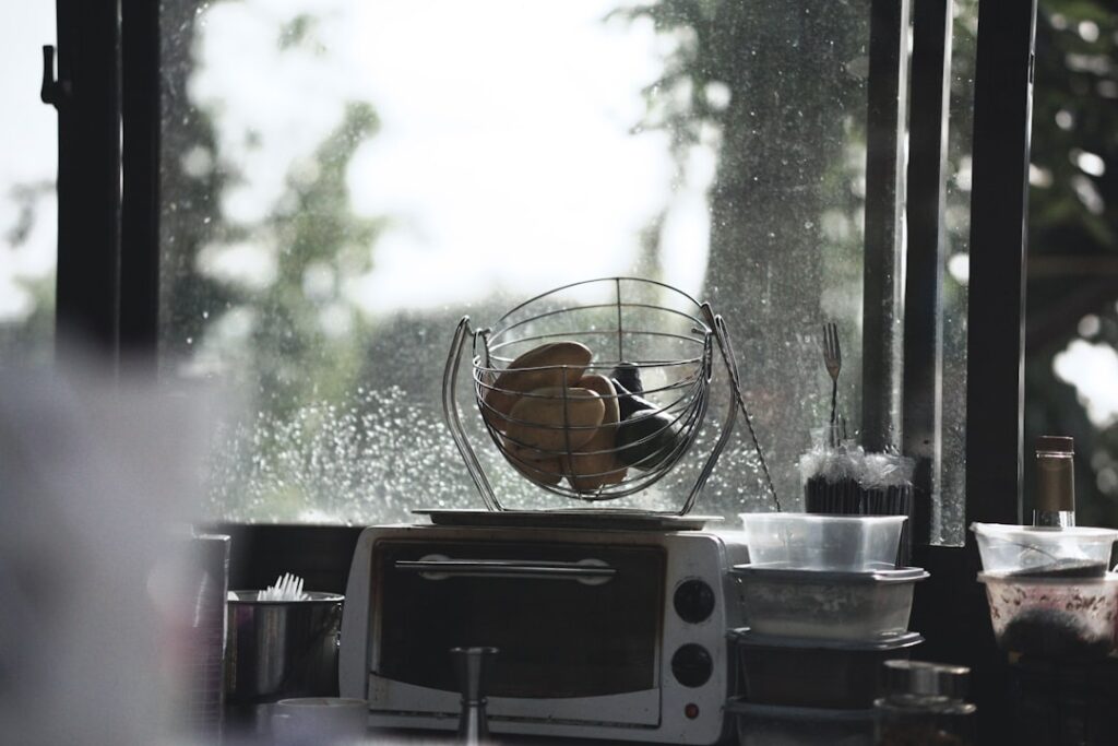 a toaster oven sitting on top of a counter next to a window