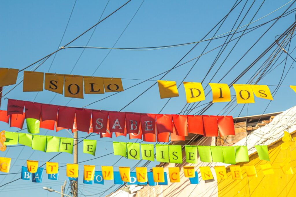 a colorful sign with a building in the background