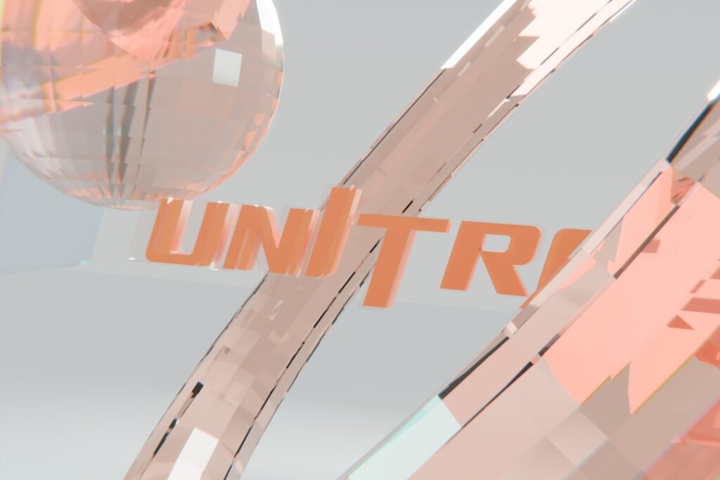 Orange 'unitri' text on a light, abstract background.